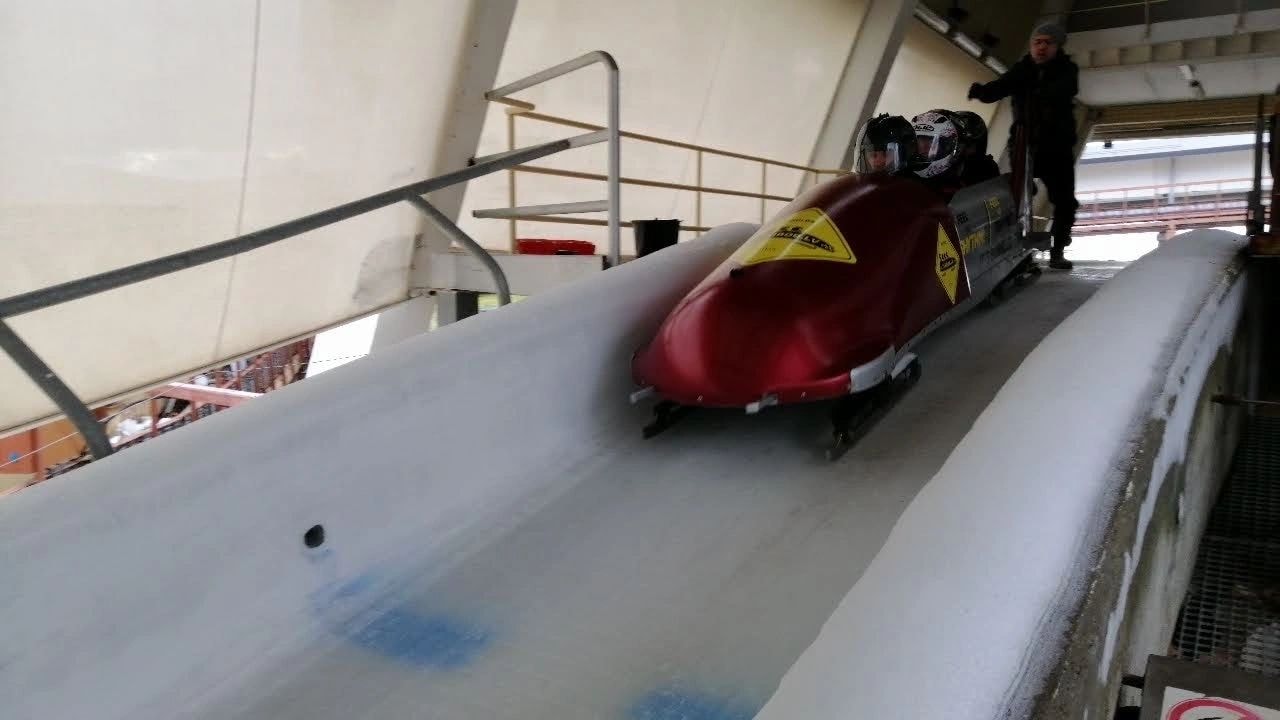 Bobsled racing down icy track